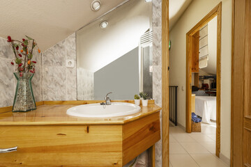 Bathroom of a house with pine wood sink cabinet