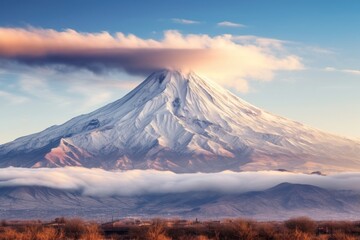 Fototapeta premium Majestic snow-capped mountain peak against a dramatic sky