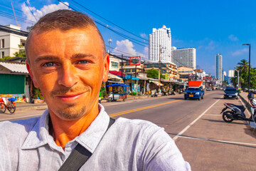 Man takes photo selfie in the city in Pattaya Thailand.