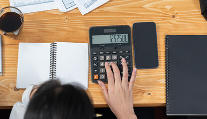Businesswoman working on wooden office workspace desk, calculating financial report. Business...