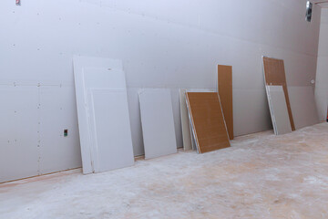 Newly constructed house walls are plasterboard drywall that are getting ready to be plastered