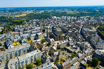 Scenic aerial view of summer cityscape of Dinan overlooking Gothic building of Catholic Church of...