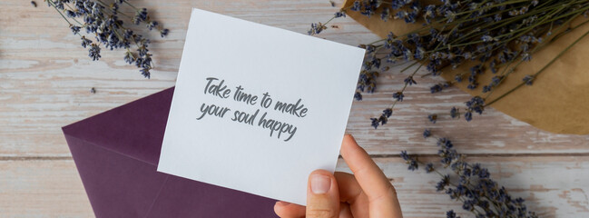 TAKE TIME TO MAKE YOUR SOUL HAPPY text on supportive message paper note reminder from green envelope. Flat lay composition dry lavender flowers. Concept of inner happiness, slowing-down digital detox - Powered by Adobe