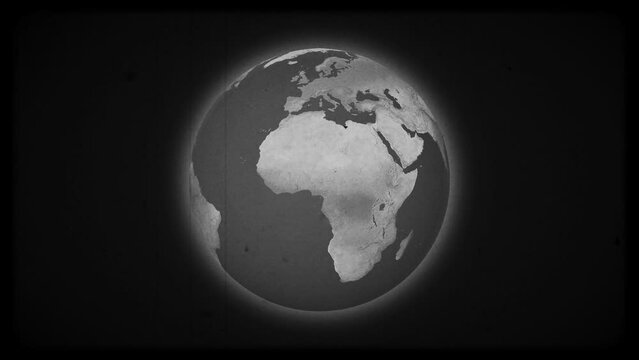 Black and white planet Earth spinning on a black background, with scratch, dusty and noise old film effects