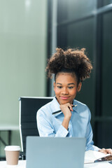 Young female African American in a blue formal shirt with afro brown hair works as a Market...
