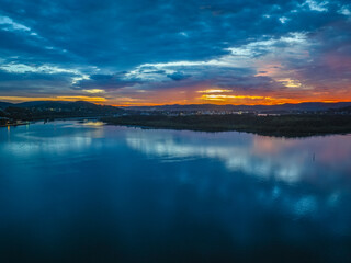 Dawn over the bay water with clouds and reflections