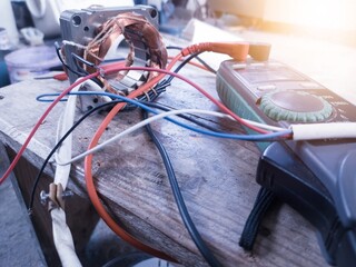 Motor winding repair concept using a multi tester to check and analyze damage.