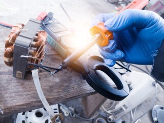 Repair and soldering of small motor windings, concept of repairing motor windings by technicians.