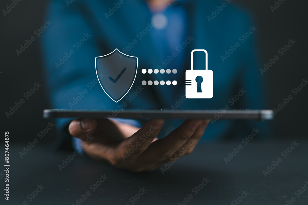 Aufkleber Cyber security. Business, technology, internet and networking concept. Young business man working on his laptop in the office, select the icon security on the virtual display.