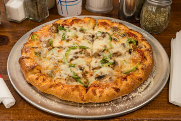 Supreme pizza with green peppers and sausage