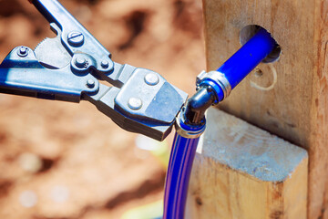 Plumber connects blue PVC pipes for water piping