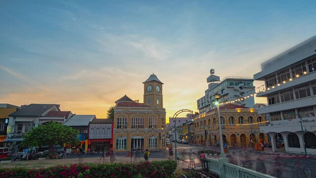 Time lapse Tourists admire the clock tower, a beautiful old building at Charter Intersection in the heart of Phuket Town.
clock tower the ancient building and popular landmark in Phuket city
