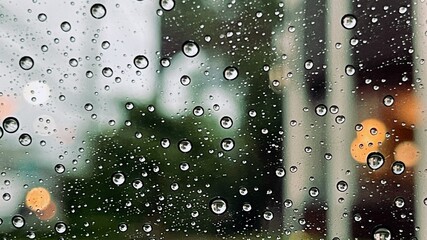 rain on window. Water droplets on the glass on a natural background 