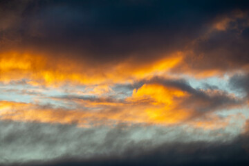 orange colored clouds with blue sky background