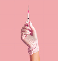the hand is wearing a light pink glove, in this hand she holds a syringe with a needle