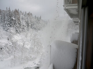 Big snowdrift falling from the roof, Japanese winter countryside scenery