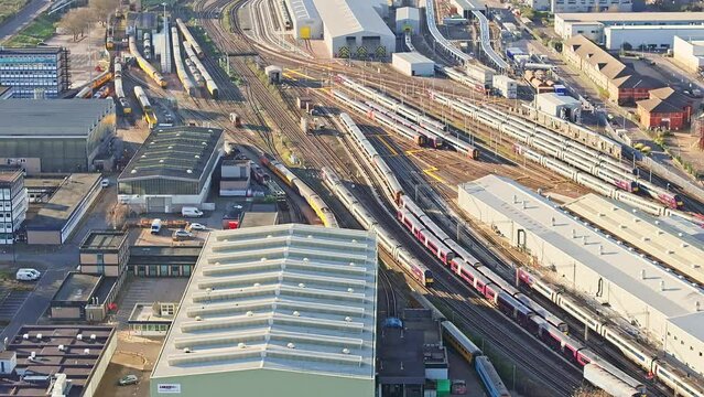 A  cinematic shot of a running train caught on a camera from the air in Derby, UK. The spectator's eye is taken from a train to a city panorama.
