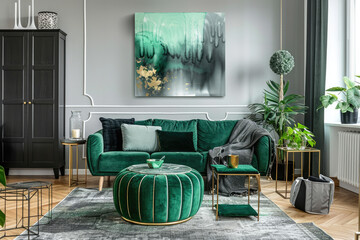 A modern living room with an emerald green sofa, gold side tables and black cabinets. A large abstract painting hangs on the wall above it