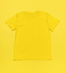 A bright yellow T-shirt on a bright yellow background.