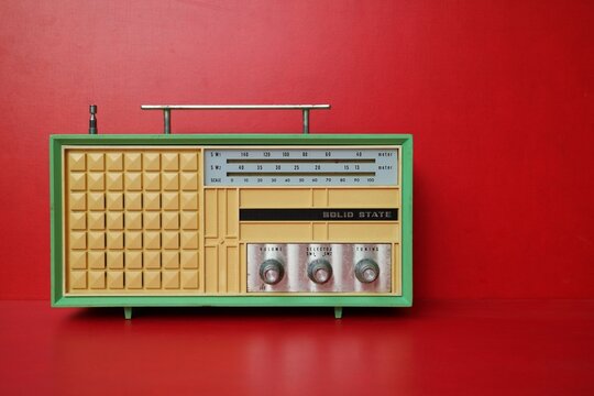vintage yellow transistor radio red wallpaper background