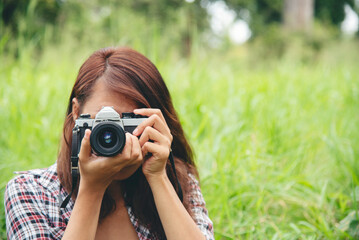 Close up hands Asian Women look at dslr digital camera vintage film style take a photo....