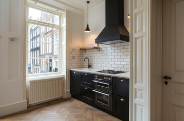A small kitchen in Amsterdam with white cabinets, a black built-in mug stand and an oven