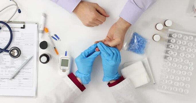 Doctor checks patients' blood sugar levels