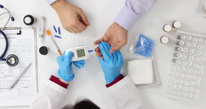 Doctor checks patient blood sugar levels