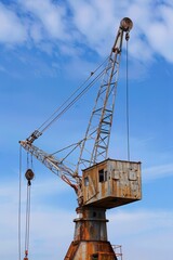 A solitary mining crane, its mechanical arms frozen in place, reaching out towards the empty sky, Generative AI 
