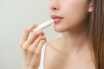 Lip care protection concept, pretty asian young woman, girl hand applying lipstick balm with...