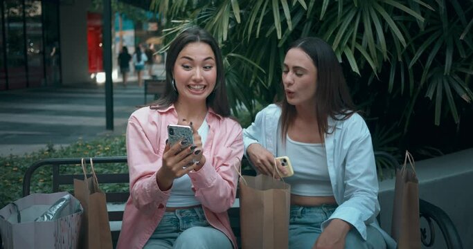 Women friends sitting bench using phones embodying positive communication. Positive communication highlights bond shared joy Positive communication blend sincerity elegance positivity.