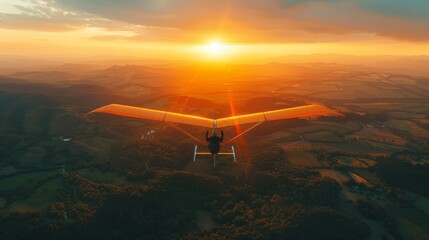 A hang glider soaring over a breathtaking landscape at sunset, with rolling hills below.