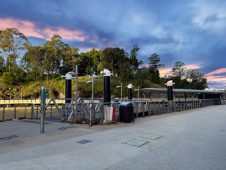 Parramatta River walkway lined with trees Ferry Wharf and High rise residential appartments on...