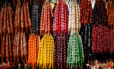 A vibrant display of Churchkhela, traditional Georgian candle-shaped candy made from grape must,...