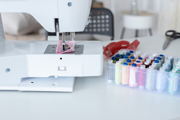 The seamstress's workplace. There are threads of different colors in the box for sewing.