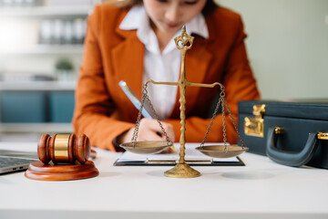 justice and law concept. Male judge in a courtroom the gavel, working with smart phone and laptop and digital tablet