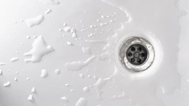 The running water drains on bathtub. Household plumbing. Cleaning and hygiene concept.