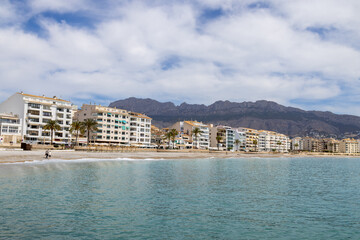 Obraz premium Photo of the beautiful beach in Altea, Alicante in Spain showing hotels and restaurants on the beach front by the pebble beach known as Playa La Roda