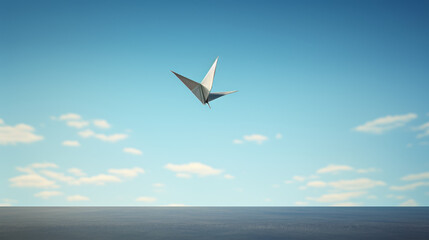 A paper bird is flying in the sky above a blue ocean