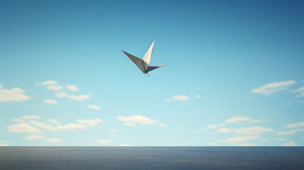Fototapeta premium A paper bird is flying in the sky above a blue ocean