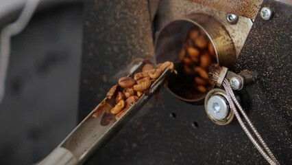 Person at a trusted coffee roaster is monitoring the roasting process