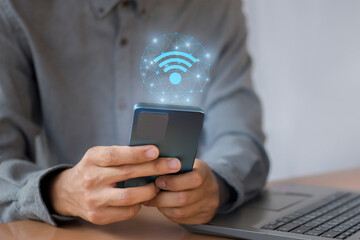 Businessman uses a mobile phone
with wifi icon, social business communication concept