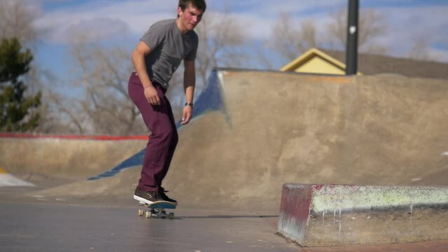 person does a skateboard grind on the ledge