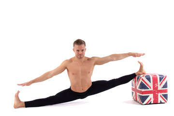 A handsome young man with an athletic body is doing fitness and yoga. White background.