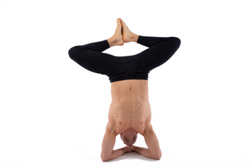 A handsome young man with an athletic body is doing fitness and yoga. White background.