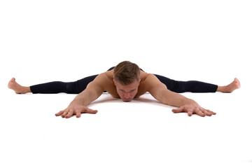 A handsome young man with an athletic body is doing fitness and yoga. White background.