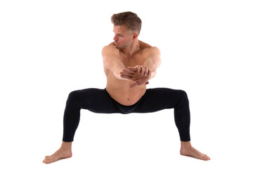 A handsome young man with an athletic body is doing fitness and yoga. White background.