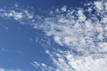 White clouds in a blue sky abstract textured background
