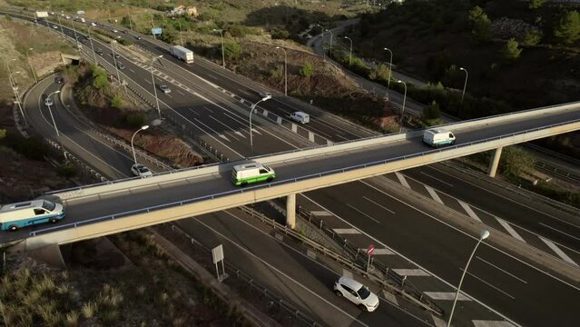 Camper vans on highway overpass in Malaga, rotation aerial drone view