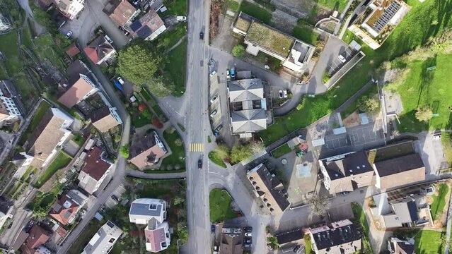 Dron view captures town view from top of Walensee Wessen Switzerland shows houses, roads, vehicles, people and greenery in side
